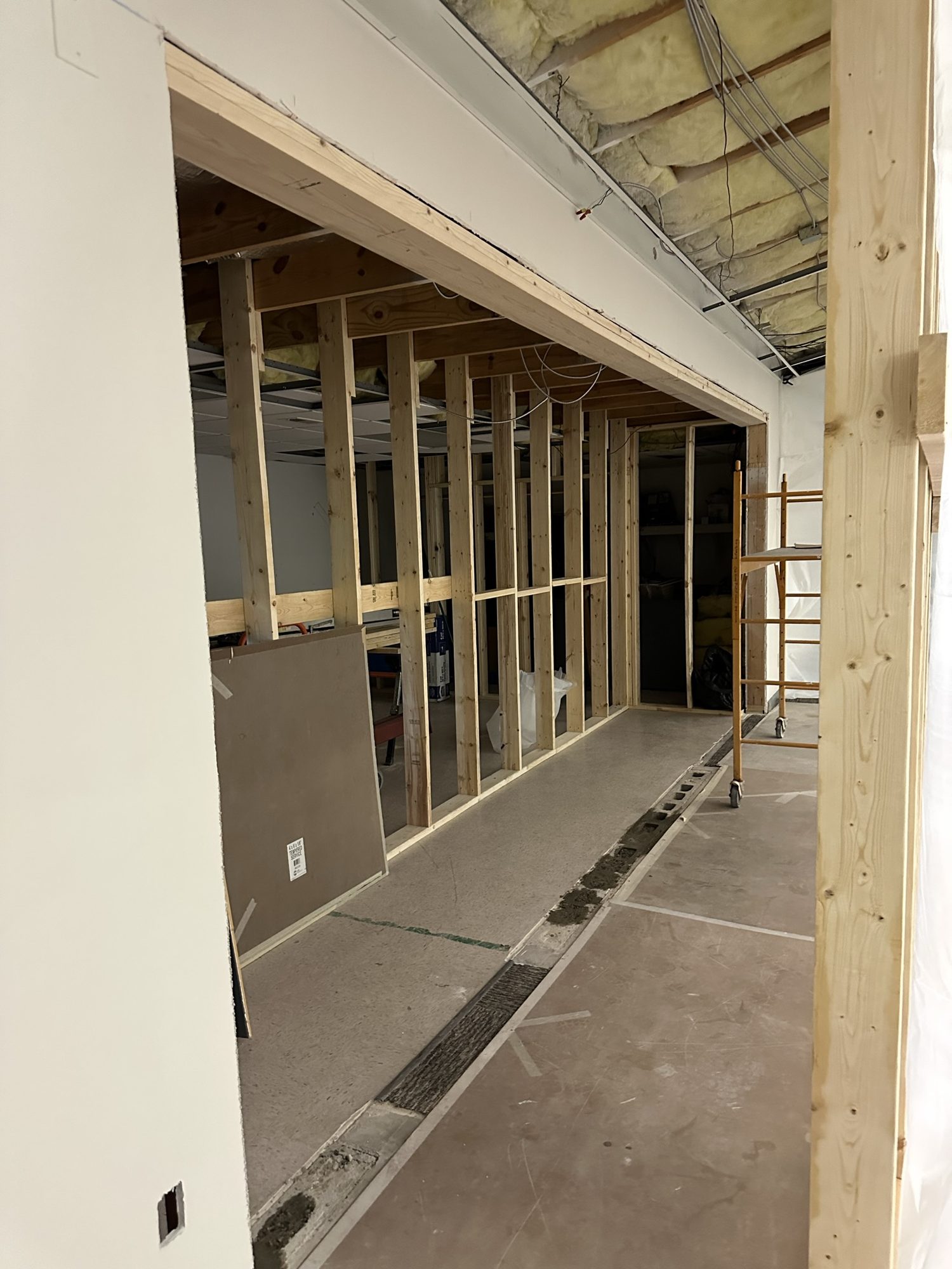New wood and metal wall framing at a corridor opening