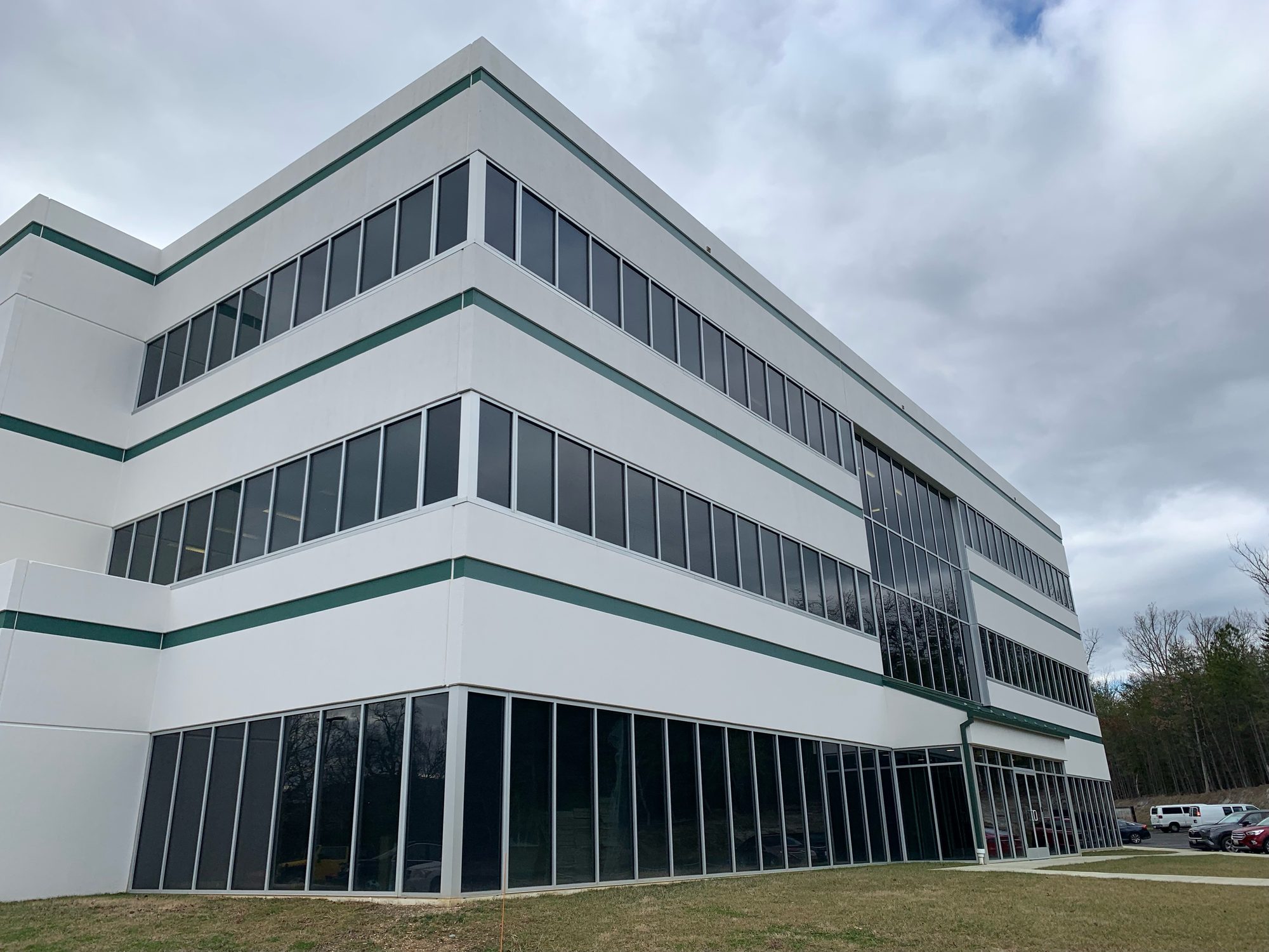 Close view of the completed building façade with glass and light-colored panels