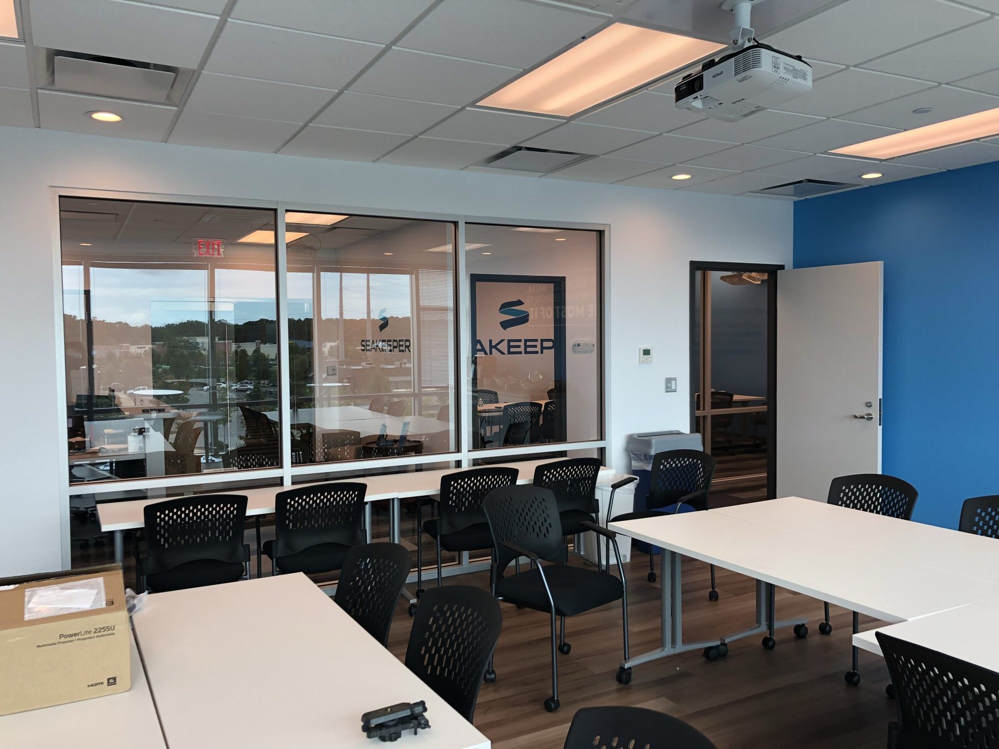 Finished meeting room with glass partitions and blue accent wall