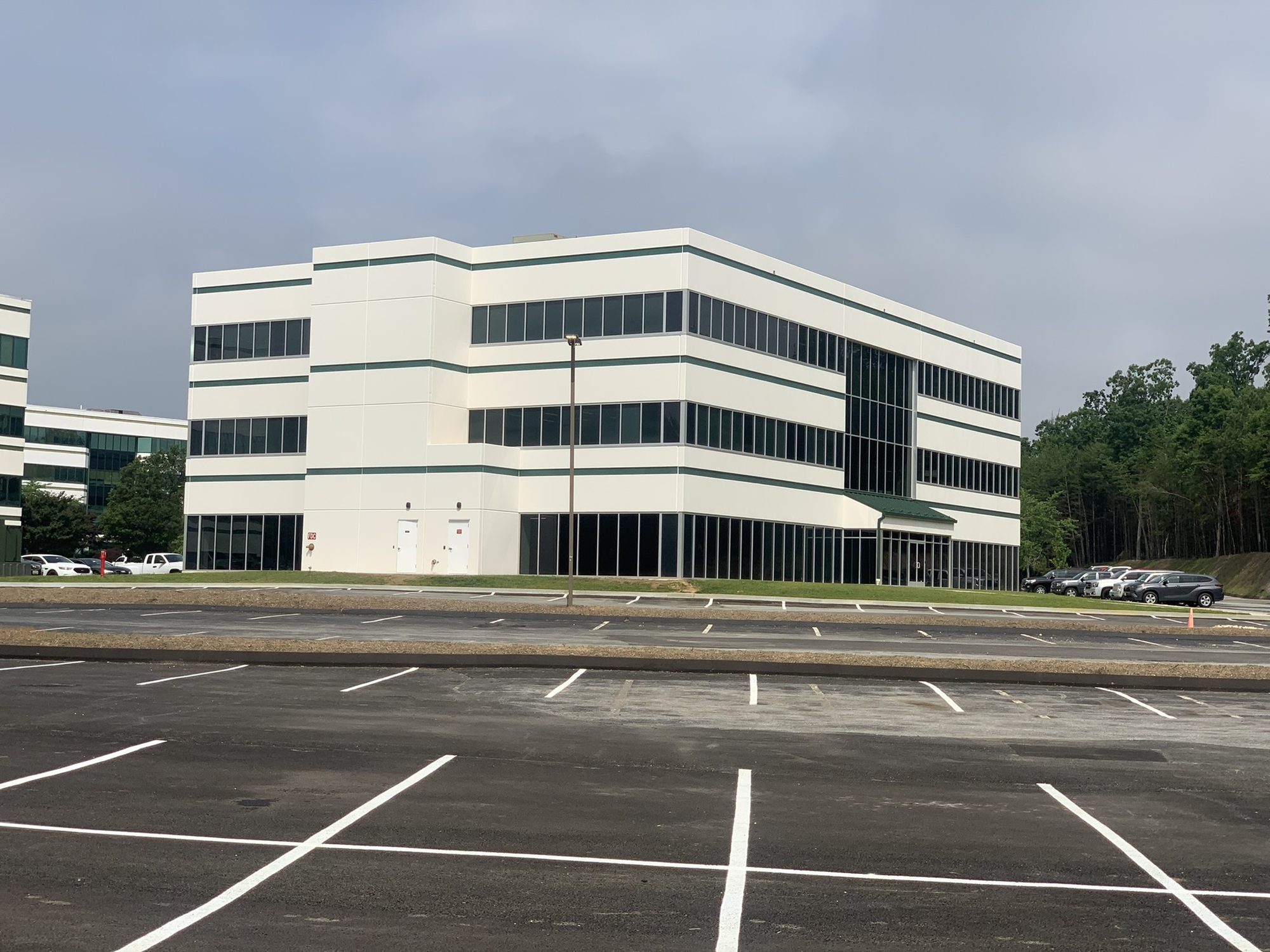 Completed multi-story building with finished parking lot and sidewalks