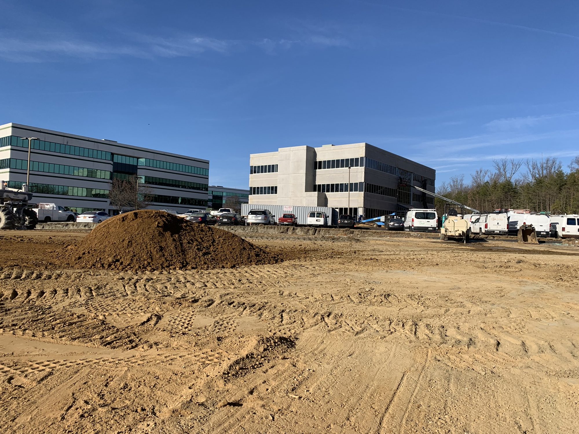 Graded construction site in front of the new building